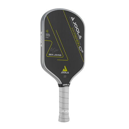 White Background Image: Ben Johns Hyperion C2 Pickleball paddle. Black surface with yellow lines and Ben Johns' signature. Grey handle and grey edge guard with white JOOLA logo.