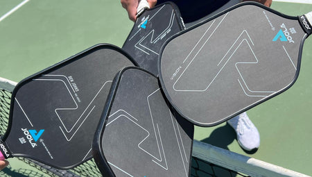 Image of four JOOLA pickleball paddles touching.