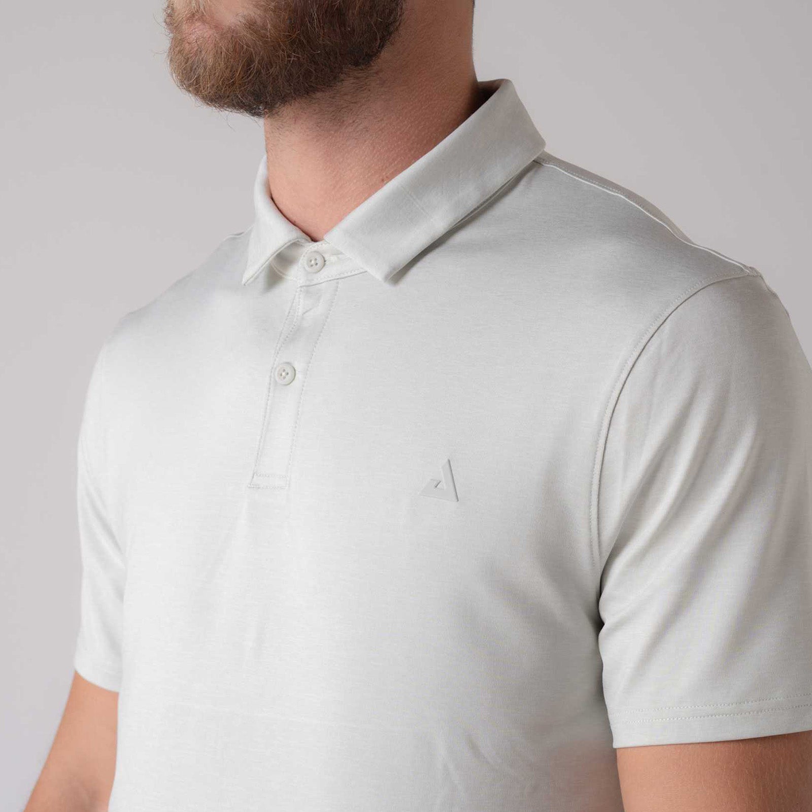 Close up of the JOOLA Men's Club Polo. The image shows the two button collar and raided JOOLA trinity logo over the left breast.