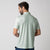 Image showing the back of a male model wearing the JOOLA Men's Club Polo, Hushed Mint.