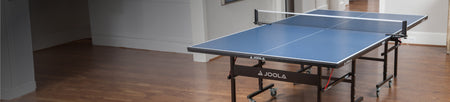 Horizontal header image of a JOOLA Table Tennis Table indoors.