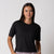 Image of a female model wearing a JOOLA Women's Court Crop Tee Shirt, Black.