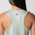 Close up image of the JOOLA Trinity logo between the shoulder blade on the back of the JOOLA Women's Court Tank, Hushed Mint.