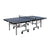 White Background Image: Full view of World Cup 25 table tennis table. Angled but show entire length of table with undercarriage, wheels, net and surface.